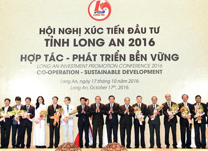 Thủ tướng Nguyễn Xuân Phúc tặng hoa cho các nhà đầu tư  tham gia hội nghị.